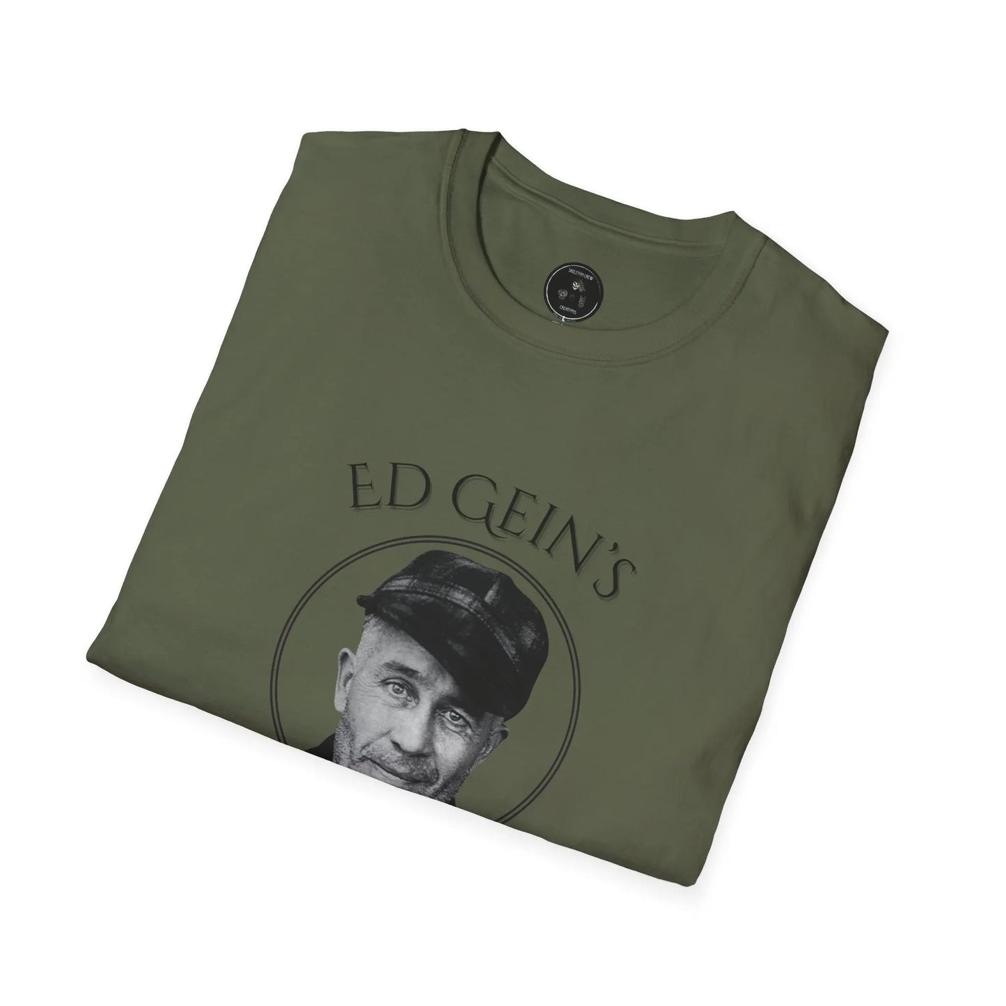 Folded green t-shirt with a graphic of a man's face and 'Ed Gein' text on a white background