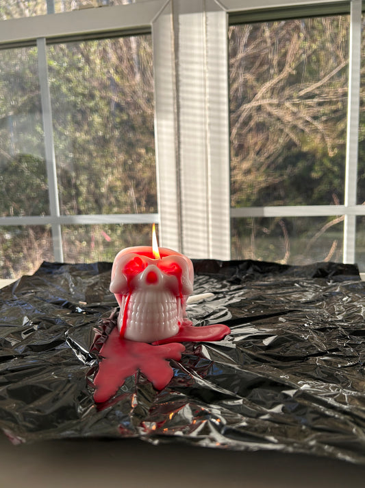 bleeding skull candle by a window