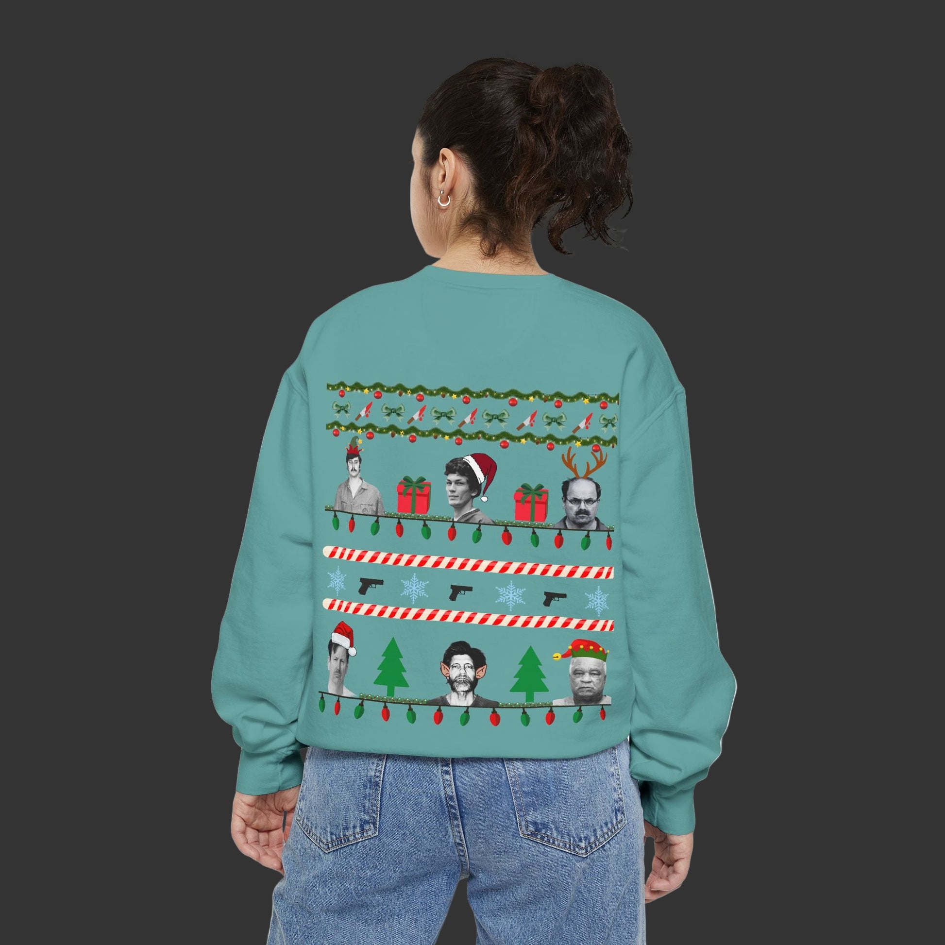 Person wearing a teal sweater with Christmas-themed designs on the back