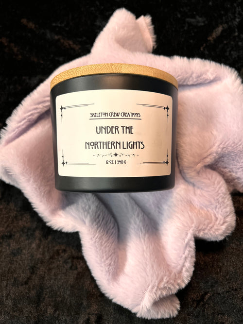 Candle with label "Under the Northern Lights" - scent notes of pine and eucalyptus