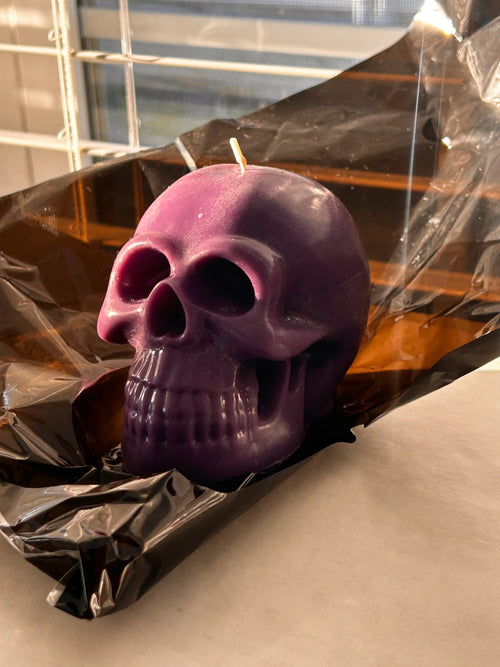 pastel purple skull candle with black wax drip effect
